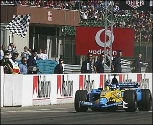 Fernando Alonso of Renault crosses the line to win the Hungarian Grand Prix