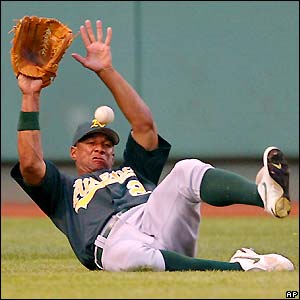 Oakland Athletics centre fielder Chris Singleton slides to stop the ball against the Boston Red Sox at Fenway Park
