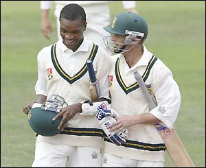 Monde Zondeki and Gary Kirsten, South Africa's two not out batsmen, leave the pitch at the close of play