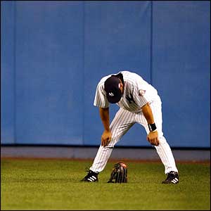 New York Yankees' Juan Rivera hangs his head during a pitching change in the seventh inning against the Boston Red Sox 