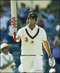 Australian left-hand opener Matthew Hayden celebrates his 15th Test century on day one of the first Test against Zimbabwe at the Waca in Perth 