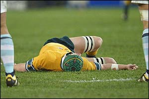 Wallaby vice-captain David Giffin is knocked unconscious after landing awkwardly on his right shoulder