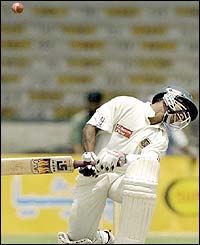 Bangladeshi batsman Rajin Salah tries to avoid a bouncer by Pakistani pace bowler Shoaib Akhter 