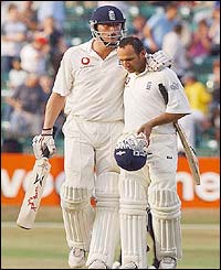 England's Andrew Flintoff and Mark Buthcer leave the field