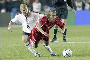 England's Paul Scholes fouls Tugay