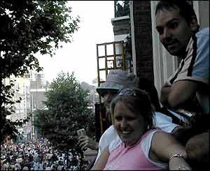 People enjoy the carnival from a flat on Ladbroke Grove