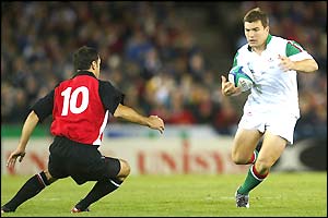 Iestyn Harris takes on the Candian fly-half