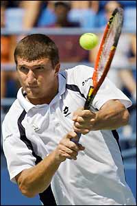 Jan Vacek of the Czech Republic plays a backhand volley