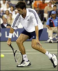 Tim Henman plays a low volley