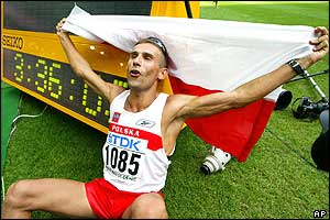 Robert Korzeniowski of Poland celebrates after setting a new world record in the men's 50km walk