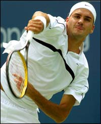 Wimbledon champion Roger Federer serves to Jose Acasuso