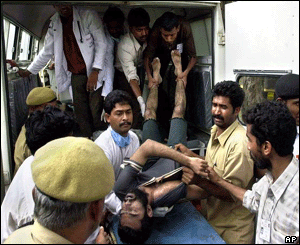 A pilgrim injured in a stampede at the Kumbh Mela is taken for treatment at the hospital in Nasik