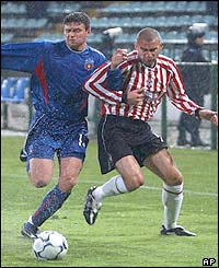 Danny Higginbotham takes on Steaua Bucharest defender Gabriel Bostina 