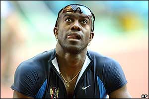 Allen Johnson of the US watches the replay of his 110m hurdles heat