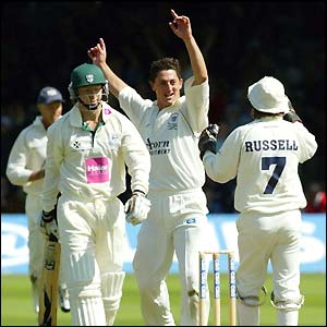 Gloucestershire's Jon Lewis celebrates dismissing Gareth Batty