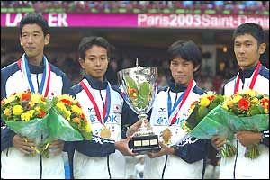 The Japanese team stand with their gold medals from the marathon team event 