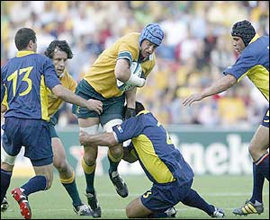 Nathan Sharpe is tackled by a Romanian forward