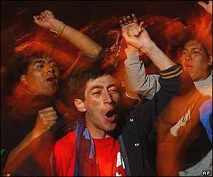 Bolivian men shout as news of the president's resignation emerges