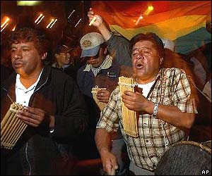 Protesters playing pan pipes 