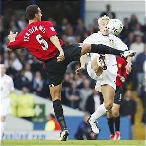 Rio Ferdinand holds off Leeds striker Alan Smith