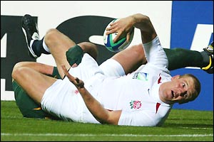 Tindall gets tackled just short of the line