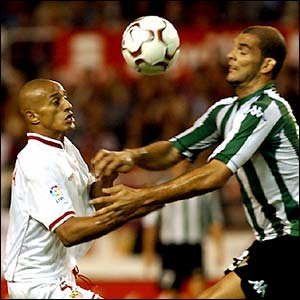 Sevilla's Dario Silva vies with Rivas of Real Betis during their La Liga match in Seville