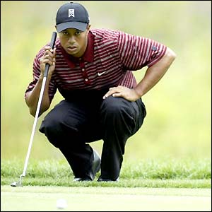 Tiger Woods of the USA looks over a putt on the third green during the final round of the Deutsche Bank Championship at the TPC of Boston 