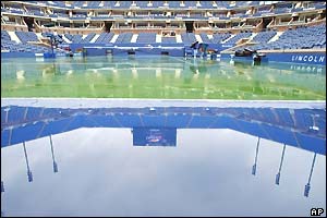 Rain covers the Arthur Ashe court at Flushing Meadows at the start of day nine