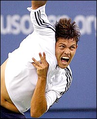 Taylor Dent serves to Andre Agassi in their fourth round match at the US Open
