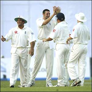 Steve Harmison (centre) of England is congratulated on taking a wicket