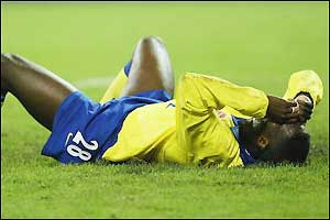 Toure lies prostrate on the ground after his side's disappointing defeat