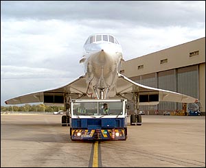 Concorde about to be towed from the BA engineering base at Heathrow, across a public road to Terminal 4 for her 1830 flight to New York, October 4 2003, by Stephen Daniels from Scotland