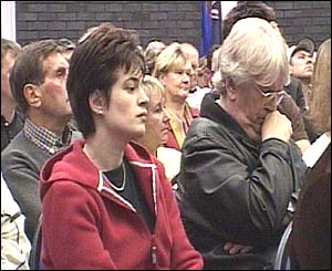Xanthe Bates and her father Victor attend a meeting on gun crime in Nottingham on Thursday after her mother Marion was killed in an attack on thier family shop last month