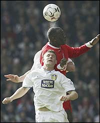 Emile Heskey battles for the ball with James Milner