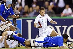 England's Jason Robinson looks on as Semo Sititi goes over in the corner to score for Samoa