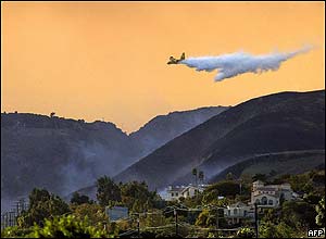 An air tanker drops water on a wildfire in Malibu.