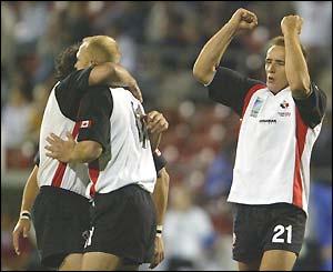 Canada celebrate a 24-7 win - their first and only victory of the group stages