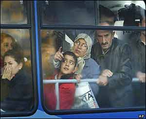 Istanbul commuters look at the HSBC bank building as their bus passes by the site