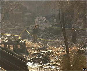 Two people walk through the rubble of the British Consulate in Istanbul, Turkey