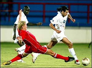 Al-Arabis' Stefan Effenberg attempts to tackle Youssef Chippo of al-Sadd during their Qatari league match at al-Rayan stadium in Doha