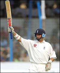 Nasser Hussain waves his bat to the crowd on reaching fifty
