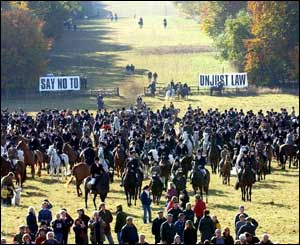 Riders with the Beaufort Hunt and banners reading Say No To Unjust Law