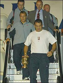 Jonny Wilkinson, Clive Woodward and Martin Johnson disembark at Heathrow 