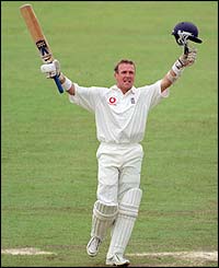 Alec Stewart celebrates making a memorable century at Old Trafford in his 100th Test 