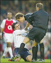 Referee Mark Halsey calms Lehmann and Postiga down