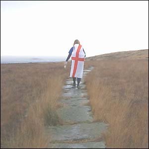 Merrian Lancaster walks with a cross of St George draped round her shoulders
