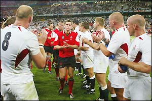The England team clap the Wales players off the field