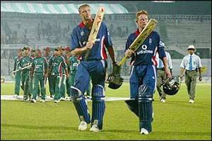 Andrew Flintoff and Paul Collingwood leave the pitch after England's win