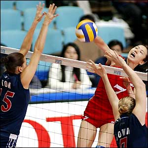 China's Zhou Suhong spikes the ball over the net during the World Cup women's volleyball tournament