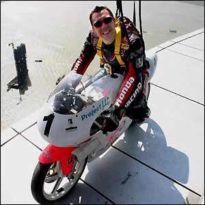 The UK's Gus Scott rides his bike along edge of the 233-metre high Macau Tower